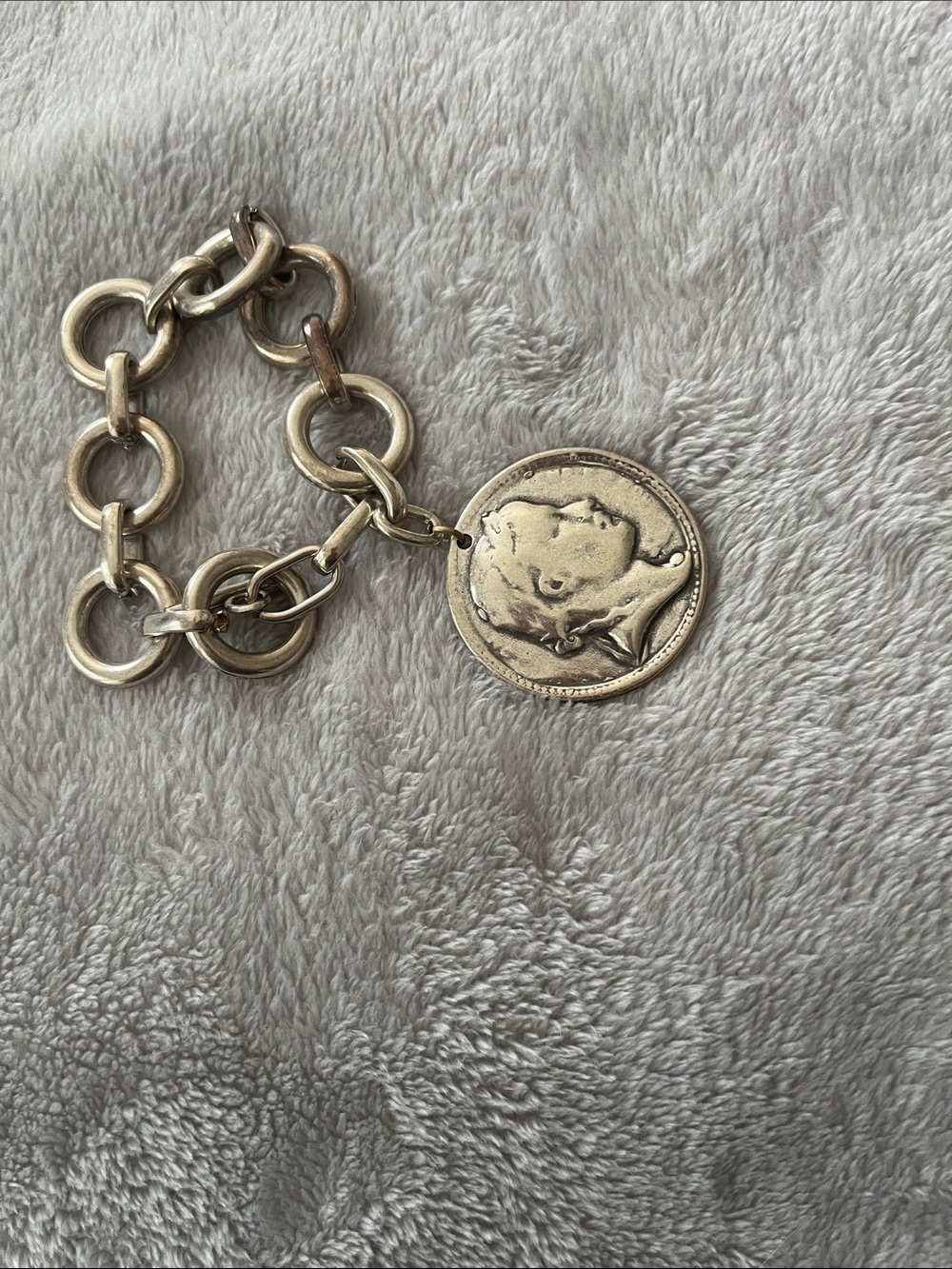 Silver tone coin bracelet.